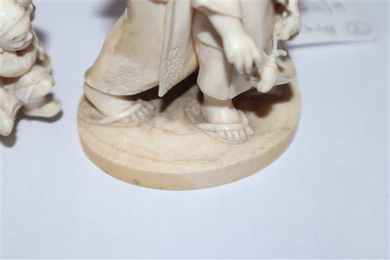 A Meiji carved ivory group of two children (damaged) on hardwood stand and a smaller group tallest 14cm incl. stand